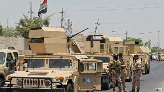 Vehicles of the Iraqi army block the entrance to the capital Baghdad's suburb of Sadr City on May 21, 2020, during a COVID-19 testing campaign as part of measures taken by the authorities aimed at containing the spread of the novel coronavirus. - Certain neighbourhoods in the Iraqi capital Baghdad began a full lockdown for two weeks as of yesterday, in reaction to a spike in coronavirus infections since restrictions were relaxed. (Photo by AHMAD AL-RUBAYE / AFP)