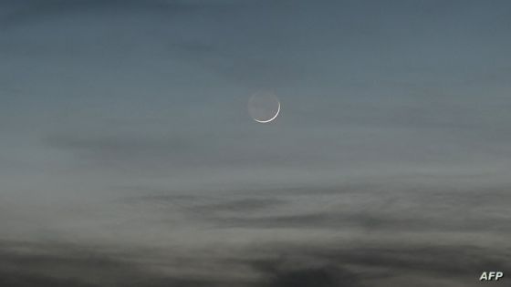 A crescent moon is seen during dusk in Manila on November 25, 2022. (Photo by JAM STA ROSA / AFP)