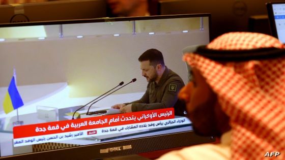 Media delegates watch Ukraine's President Volodymyr Zelensky addressing the Arab League Summit in Jeddah on May 19, 2023. Zelensky accused some Arab leaders of ignoring the horrors of Russia's invasion of his country during a speech today at an Arab League summit in Saudi Arabia. (Photo by Fayez Nureldine / AFP)