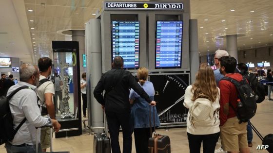 Passengers look at a departure board at Ben Gurion Airport near Tel Aviv, Israel, on October 7, 2023, as flights are canceled because of the Hamas surprise attacks. The conflict sparked major disruption at Tel Aviv airport, with American Airlines, Emirates, Lufthansa and Ryanair among carriers with cancelled flights. (Photo by GIL COHEN-MAGEN / AFP)