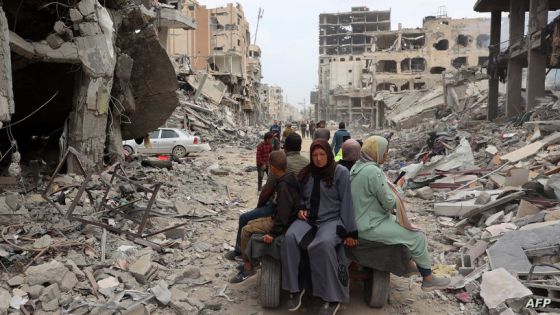 A Palestinian family rides on the back of a donkey-drawn carriage next to damaged buildings in Khan Yunis on April 8, 2024 after Israel pulled its ground forces out of the southern Gaza Strip, six months into the devastating war sparked by the October 7 attacks. (Photo by AFP)