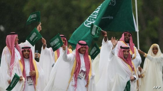 PARIS, FRANCE - JULY 26: Athletes of Team Saudi Arabia are seen waving their flag on a boat along the River Seine during the opening ceremony of the Olympic Games Paris 2024 on July 26, 2024 in Paris, France. (Photo by Steph Chambers / POOL / AFP)