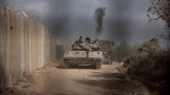 PHOTO TAKEN DURING A CONTROLLED EMBED TOUR WITH THE ISRAELI ARMY AND SUBSEQUENTLY EDITED UNDER MILITARY SUPERVISION -- This picture taken on October 13, 2024 shows an Israeli battle tank entering Lebanon from northern Israel at the southern Lebanese border point of Naqoura. UN peacekeepers in Lebanon said Israeli tanks broke through a gate to enter a Blue Helmet position in Lebanon on October 13, after blocking their movement the previous day. (Photo by Menahem KAHANA / AFP)