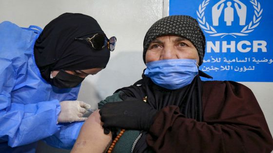 A Syrian refugee receives the Coronavirus vaccine, at a medical center in the Zaatari refugee camp, 80 kilometers (50 miles) north of the Jordanian capital Amman on February 15, 2021. (Photo by Khalil MAZRAAWI / AFP)