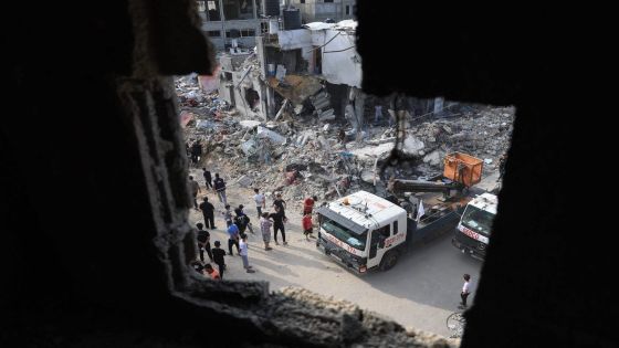 A truck clears the rubble around buildings destroyed during Israeli airstrikes on Rafah in the southern Gaza Strip, on October 8, 2023. Fighting between Israeli forces and the Palestinian militant group Hamas raged on October 8, with hundreds killed on both sides after a surprise attack on Israel prompted Prime Minister Benjamin Netanyahu to warn they were "embarking on a long and difficult war". (Photo by SAID KHATIB / AFP)