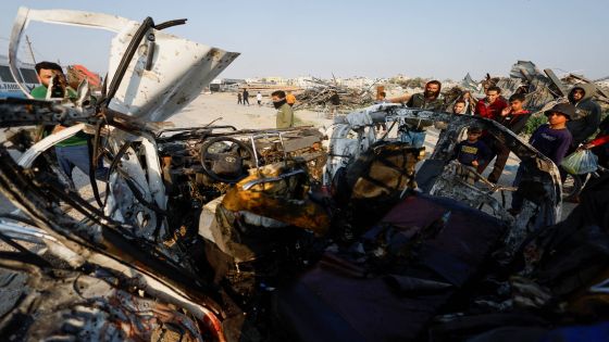 Palestinians inspect the site of an Israeli airstrike targeting a police vehicle in the central Gaza Strip, March 15, 2026. REUTERS/Mahmoud Issa