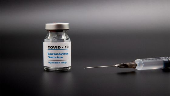 Small vaccine bottle (phial) with a label that read "Covid - 19 Corona virus Vaccine injection only" & a medical syringe isolated on black Vaccination for prevention, immunization & treatment to virus; Shutterstock ID 1786528445; Department: -
