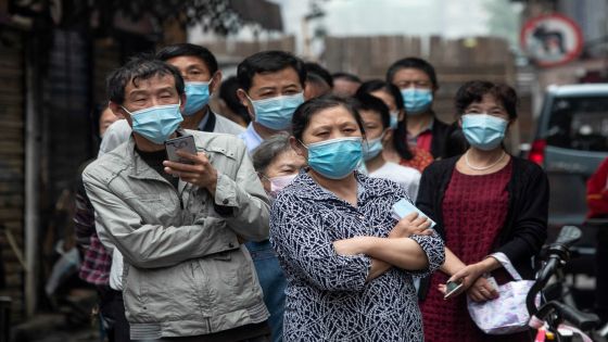 Residents wait in line to provide swab samples to be tested for the COVID-19 coronavirus, in a street in Wuhan in China's central Hubei province on May 15, 2020. - Authorities in the pandemic ground zero of Wuhan have ordered mass COVID-19 testing for all 11 million residents after a new cluster of cases emerged over the weekend. (Photo by STR / AFP) / China OUT