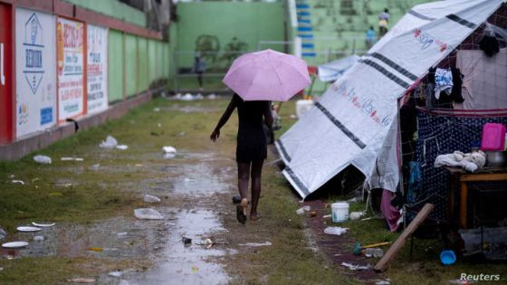 FILE PHOTO: A woman walks next to a tarp in a makeshift camp after tropical depression Grace passed through the area following Saturday's 7.2 magnitude quake, in Les Cayes, Haiti August 17, 2021. REUTERS/Ricardo Arduengo/File Photo