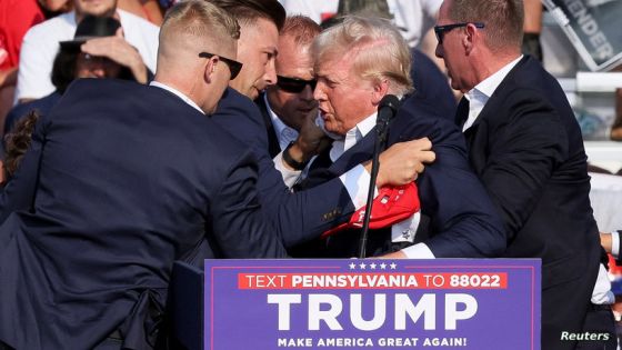 Republican presidential candidate and former U.S. President Donald Trump is assisted by guards during a campaign rally at the Butler Farm Show in Butler, Pennsylvania, U.S., July 13, 2024. REUTERS/Brendan McDermid TPX IMAGES OF THE DAY