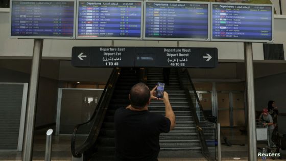 A man takes a picture of flight information boards at the Beirut–Rafic Hariri International Airport, in Beirut, Lebanon July 29, 2024. REUTERS/Emilie Madi