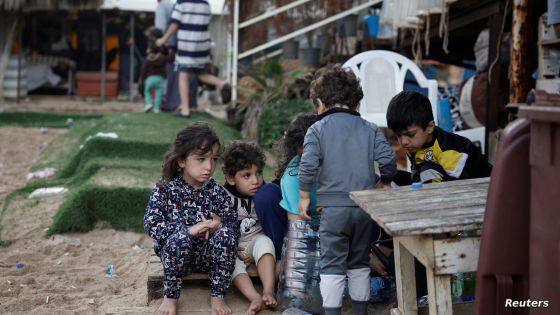 Displaced children play at a makeshift encampment where scores of displaced people live, amid cross-border hostilities between Hezbollah and Israeli forces, at a beach in Beirut, Lebanon, October 1, 2024. REUTERS/Louisa Gouliamaki