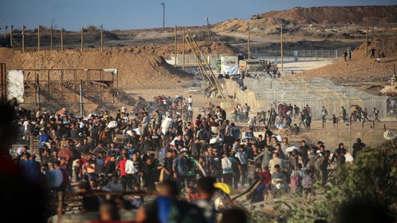 TOPSHOT - Palestinians gather at an aid distribution point set up by the privately-run Gaza Humanitarian Foundation (GHF), near the Nuseirat refugee camp in the central Gaza Strip on June 25, 2025. (Photo by Eyad BABA / AFP) (Photo by EYAD BABA/AFP via Getty Images)