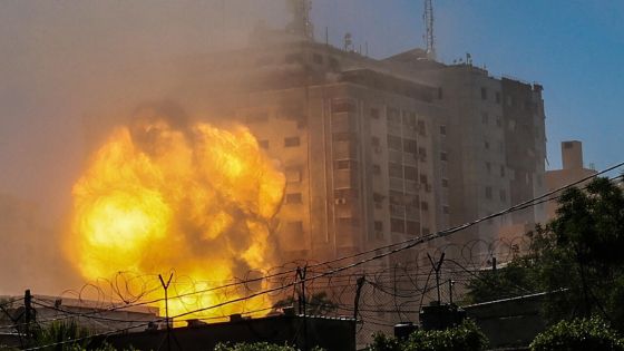 A thick column of smoke rises from the Jala Tower as it is destroyed in an Israeli airstrike in Gaza city controlled by the Palestinian Hamas movement, on May 15, 2021. - Israeli air strikes pounded the Gaza Strip, killing 10 members of an extended family and demolishing a key media building, while Palestinian militants launched rockets in return amid violence in the West Bank. Israel's air force targeted the 13-floor Jala Tower, Qatar-based Al-Jazeera television and the Associated Press news agency.