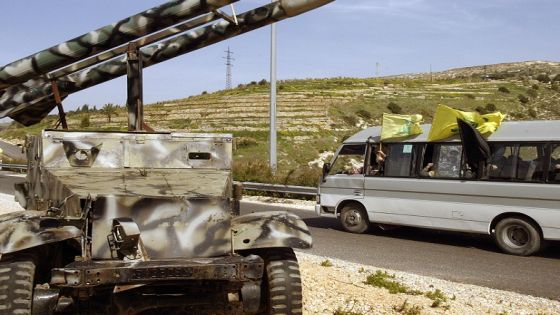 A bus carrying Hezbollah supporters drives past a jeep laden with replicas of 2 missiles as they drive towards the Lebanese capital Beirut from Abu al-Aswad in the south of the country on February 22, 2008. The Shiite Muslim Hezbollah movement organized a rally today to mark the recent killing of one of its top militants, Imad Mughnieh, and the 1992 assassination of its former leader Abbas Mussawi in an Israeli helicopter strike. AFP PHOTO/MAHMOUD ZAYYAT (Photo by MAHMOUD ZAYYAT / AFP)