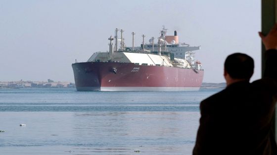 An Egyptian man looks at the Qatari Liquefied Natural Gas (LNG) carrier "Duhail" as its passes through the Suez Canal near the Egyptian port city of Ismailia on April 1, 2008. The vessel has a capacity of 210,100 cu.m making it one of the largest LNG carriers constructed to date. AFP PHOTO/STR (Photo by AFP) (Photo by -/AFP via Getty Images)