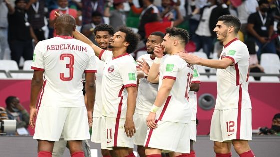 DOHA, QATAR - DECEMBER 03: Akram Afif of Qatar celebrates with teammates after scoring their team's first goal during the FIFA Arab Cup Qatar 2021 Group B match between Oman and Qatar at Education City Stadium on December 03, 2021 in Doha, Qatar. (Photo by Oliver Hardt - FIFA/FIFA via Getty Images)