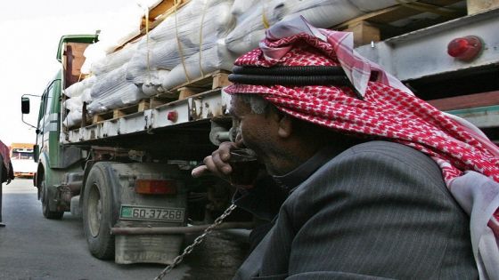 Drivers wait by their trucks loaded with humanitarian aid at the King Hussein Bridge crossing in Amman, before departing for the Gaza Strip on December 29, 2008. Israel bombed Gaza for a third day in an "all-out war" on Hamas, as tanks massed on the border and the Islamists fired deadly rockets to retaliate for the blitz that has killed nearly 320. Anger over the mammoth bombing campaign spiralled in the Muslim world, UN Secretary General Ban Ki-moon again deplored the violence, and efforts to hold talks between Syria and Israel were suspended as a result of the bombardment. AFP PHOTO/KHALIL MAZRAAWI (Photo credit should read KHALIL MAZRAAWI/AFP/Getty Images)