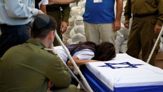 The mother of Israeli soldier Colonel Asaf Hamami mourns over her son's casket at his funeral in Tel Aviv, Israel December 4, 2023. Hamami was killed defending Kibbutz Nirim during the deadly October 7 attack by Palestinian Islamist group Hamas. According to the Israeli army, his body was taken to Gaza by Hamas, but enough findings were gathered to allow for his burial. REUTERS/Shir Torem TPX IMAGES OF THE DAY