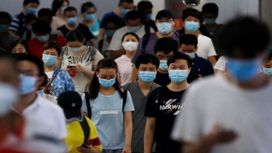 People wearing face masks following the coronavirus disease (COVID-19) outbreak walk at a subway station in Beijing, China July 14, 2020. REUTERS/Tingshu Wang