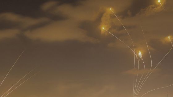 Israel's Iron Dome air defence system (R) intercepts rockets (L) launched from Gaza City on May 13, 2023. Israeli air strikes battered Gaza again on May 13 in response to rocket fire from militants as deadly fighting resumed after a night of relative calm, despite efforts to secure a truce. (Photo by MOHAMMED ABED / AFP)