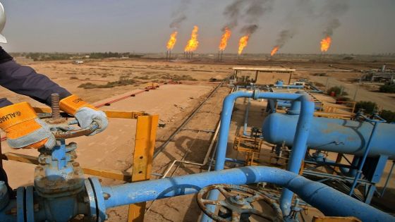 An Iraqi oil technician turns a valve at a gas installation as flames resulting from the burning of excess hydrocarbons rise in the background at the Nahr Bin Omar natural gas field, north of the southern Iraqi port of Basra on January 22, 2018.
Iraq will is expected to sign a memorandum of understanding with US energy company Orion on January 22 to tap gas at the oil field in the south of the country, the petroleum ministry said. The Nahr Bin Omar field, situated in the hydrocarbon-rich Basra province, is currently producing 40,000 barrels of oil a day, but only a small part of the gas from the field is being exploited. / AFP PHOTO / HAIDAR MOHAMMED ALI (Photo credit should read HAIDAR MOHAMMED ALI/AFP/Getty Images)