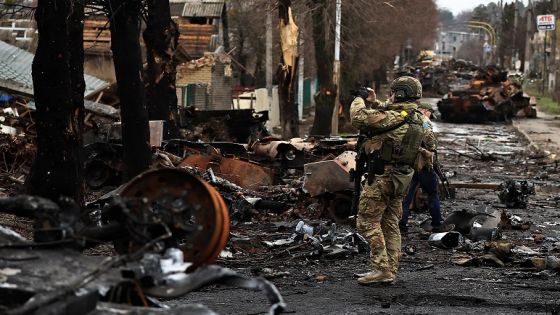 A serviceman uses his mobile phone to film a destroyed Russian tank and armoured vehicles, amid Russia's invasion on Ukraine in Bucha, in Kyiv region, Ukraine April 2, 2022. REUTERS/Zohra Bensemra