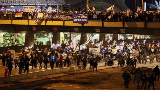 Supporters of Israel's Prime Minister Benjamin Netanyahu (not pictured) rally in support of his government's controversial juducial overhaul bill on an avenue in Tel Aviv, on March 30, 2023. (Photo by JACK GUEZ / AFP) (Photo by JACK GUEZ/AFP via Getty Images)