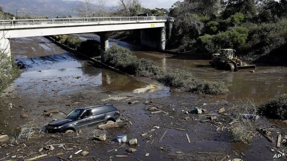 FILE - A bulldozer moves debris as a vehicle sits stranded in flooded water on U.S. Highway 101 in Montecito, Calif., Jan. 10, 2018. Experts say California has learned important lessons from the Montecito tragedy, and the state has more tools to pinpoint the hot spots and more basins and nets are in place to capture the falling debris before it hits homes. (AP Photo/Marcio Jose Sanchez, File)