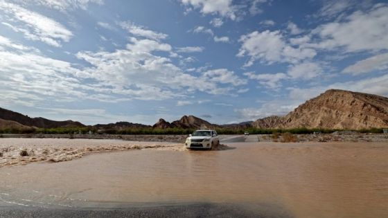 A car drives through flood water in the Wadi Bayh valley of the Gulf emirate of Ras el-Khaima, on July 28, 2022, following torrential rains. (Photo by Giuseppe CACACE / AFP)