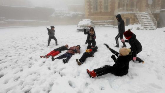 Palestinians play with snow during a snowstorm in Hebron in the Israeli-occupied West Bank February 18, 2021. REUTERS/Mussa Qawasma