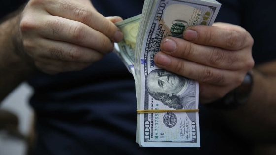 A man counts a pile of US Dollar bank notes in the Iraqi capital Baghdad on May 4, 2020, during the novel coronavirus pandemic crisis. - With its financial outlook darkening by the day, Iraq is considering slashing its massive public payroll -- an unpopular move likely to renew protests.
OPEC's second-largest producer has been hit hard by the double-whammy of collapsed crude prices and the COVID-19 pandemic, which have hacked at its revenues from oil sales. (Photo by AHMAD AL-RUBAYE / AFP)