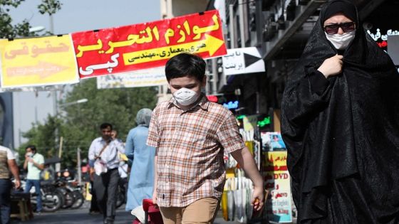An Iranian woman and her son wearing a protective face mask walks the street, following the outbreak of the coronavirus disease (COVID-19), in Tehran, Iran, June 28, 2020. WANA (West Asia News Agency) via REUTERS ATTENTION EDITORS - THIS PICTURE WAS PROVIDED BY A THIRD PARTY