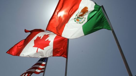 FILE - National flags representing the United States, Canada, and Mexico fly in the breeze in New Orleans where leaders of the North American Free Trade Agreement met on April 21, 2008. (AP Photo/Judi Bottoni, File)