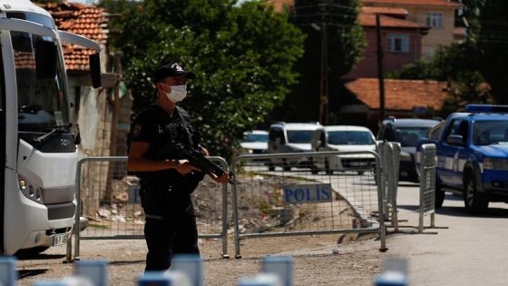 A Turkish riot police member stands guard at a check point on a road which leads to a neighbourhood where many Syrian refugees have houses and shops, after a crowd of Turks attacked shops and homes belonging to Syrians overnight, in the wake of a street fight that led to a Turkish youth being fatally stabbed, in Ankara, Turkey August 12, 2021. REUTERS/Cagla Gurdogan