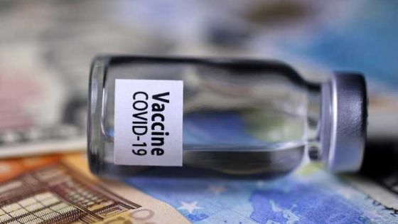 This illustration picture shows a vial reading "Covid-19 Vaccine" with euro banknotes, in Paris, on November 26, 2020 . (Photo by JOEL SAGET / AFP)