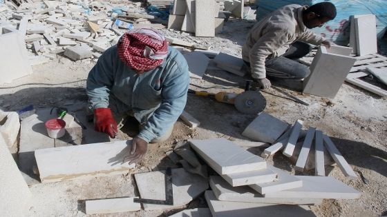 Works cut limestones at a site where an apartment building is being constructed in Amman on January 8, 2009. Jordanians are snapping up houses despite soaring prices and warnings from analysts in the six-billion-dollar housing sector that a property "disaster" is looming. New units are being constructed as a demand for housing is expected to rise in Jordan over 2009. AFP PHOTO/AWAD AWAD (Photo by AWAD AWAD / AFP) (Photo by AWAD AWAD/AFP via Getty Images)