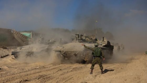 An Israeli soldier gestures as military vehicles manoeuvre, amid the ongoing ground invasion against Palestinian Islamist group Hamas in the northern Gaza Strip, November 8, 2023. REUTERS/Ronen Zvulun