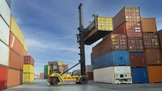 Crane lifting up container in yard