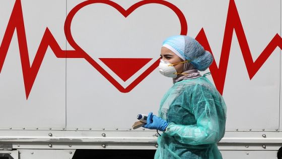 A Jordanian doctor walks next a mobile clinic that is operated as part of initiative that was launched with the aim of providing Jordanians with field medical services, amid concerns over the spread of the coronavirus disease (COVID-19), in Amman, Jordan, March 30, 2020. Picture taken March 30, 2020. REUTERS/Muhammad Hamed - RC2YUF9FKPPE