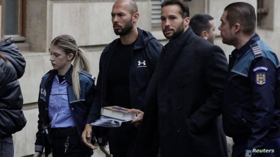 Andrew Tate and his brother Tristan are escorted by police officers outside the headquarters of the Bucharest Court of Appeal, in Bucharest, Romania, January 10, 2023. Inquam Photos/Octav Ganea via REUTERS ATTENTION EDITORS - THIS IMAGE WAS PROVIDED BY A THIRD PARTY. ROMANIA OUT. NO COMMERCIAL OR EDITORIAL SALES IN ROMANIA