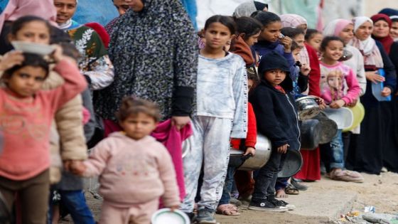 Palestinians stand in a line as they wait to receive food amid shortages of food supplies, amid the ongoing conflict between Israel and the Palestinian Islamist group Hamas, in Rafah in the southern Gaza Strip January 17, 2024. REUTERS/Mohammed Salem