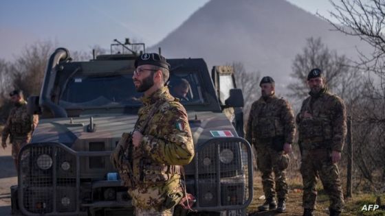 Italian soldiers serving in a NATO-led international peacekeeping mission in Kosovo patrol near a road barricaded with trucks by Serbs in the village of Rudare near the town of Zvecan on December 26, 2022. (Photo by Armend NIMANI / AFP)