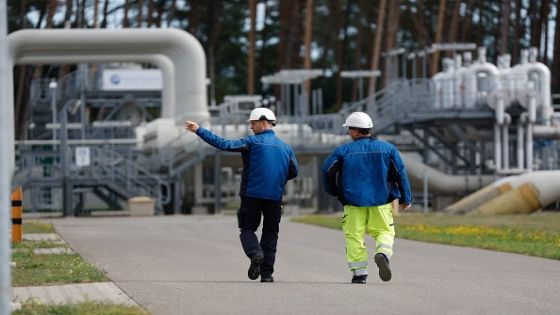 Workers walk past facilities to receive and distribute natural gas on the grounds of gas transport and pipeline network operator Gascade in Lubmin, northeastern Germany, close to the border with Poland, on August 30, 2022. - Lubmin's industrial infrastructure includes a receiving and distribution station for the Nord Stream 1 pipeline and is also the place where the finally canned Nord Stream 2 pipeline for more gas from Russia comes to shore. The construction of a terminal to receive LNG at the site is planned. Government measures to assure supplies of gas over the winter have prepared Germany to deal with further curbs in Russian deliveries, Chancellor Olaf Scholz said on August 30, 2022, a day before Moscow is due to cut off gas supplies for three days. (Photo by Odd ANDERSEN / AFP) (Photo by ODD ANDERSEN/AFP via Getty Images)