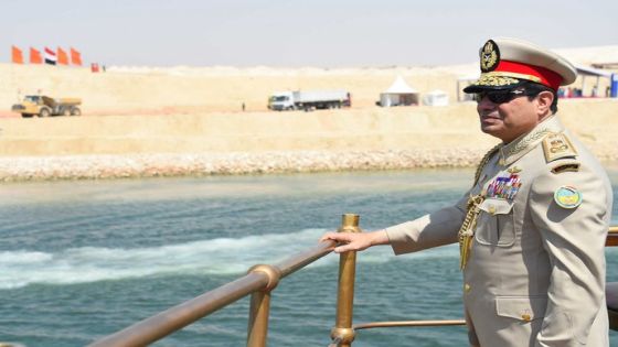 A handout picture provided by the Office of the Egyptian Presidency shows Egyptian President Abdel Fattah al-Sisi standing on an historic yacht leading a naval flotilla during a ceremony on August 6, 2015 to unveil a new waterway at the Suez Canal, in the port city of Ismailiya. AFP PHOTO / HO / EGYPTIAN PRESIDENCY / MOHAMED ABDELMOATY == RESTRICTED TO EDITORIAL USE MANDATORY CREDIT "AFP PHOTO / HO / EGYPTIAN PRESIDENCY / MOHAMED ABDELMOATY" - NO MARKETING NO ADVERTISING CAMPAIGNS - DISTRIBUTED AS A SERVICE TO CLIENTS == (Photo by MOHAMED ABDELMOATY / EGYPTIAN PRESIDENCY / AFP)