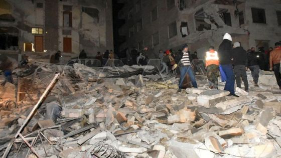 People gather at the site of a collapsed building, following an earthquake, in Hama, Syria, in this handout released by SANA on February 6, 2023. SANA/Handout via REUTERS ATTENTION EDITORS - THIS IMAGE WAS PROVIDED BY A THIRD PARTY. REUTERS IS UNABLE TO INDEPENDENTLY VERIFY THIS IMAGE. WATERMARK FROM SOURCE.