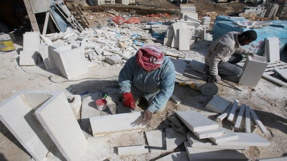 TO GO WITH AFP STORY BY AHMAD KHATIB Works cut limestones at a site where an apartment building is being constructed in Amman on January 8, 2009. Jordanians are snapping up houses despite soaring prices and warnings from analysts in the six-billion-dollar housing sector that a property "disaster" is looming. New units are being constructed as a demand for housing is expected to rise in Jordan over 2009. AFP PHOTO/AWAD AWAD (Photo credit should read AWAD AWAD/AFP/Getty Images)