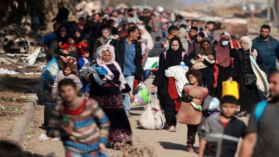 Palestinians fleeing Gaza City and other parts of northern Gaza, carry some belongings as they walk along a road leading to the southern areas of the enclave on November 18, 2023, amid ongoing battles between Israel and the Palestinian Hamas movement. (Photo by MOHAMMED ABED / AFP)