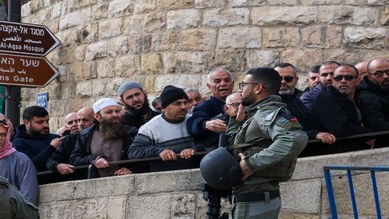 Members of the Israeli security forces stand guard as Muslim worshippers wait at a checkpoint near Lion's Gate to enter the Al-Aqsa Mosque compound for the Friday Noon prayer in Jerusalem on January 5, 2024, amid the ongoing battles between Israel and the Palestinian group Hamas. (Photo by Ahmad GHARABLI / AFP)
