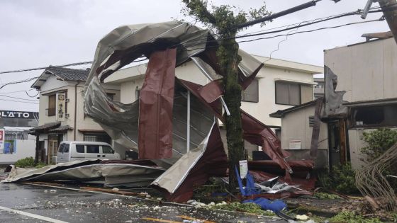 A metal object blown away by strong winds of a typhoon is caught on a power line in Miyazaki, western Japan, Thursday, Aug. 29, 2024. (Kyodo News via AP)